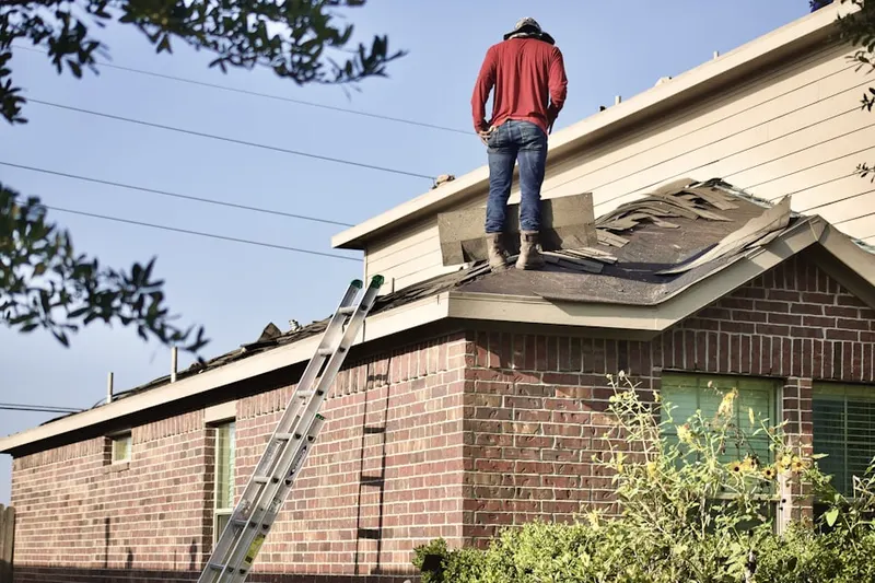 Professional roofer working on a residential roof in Fetherolfsville